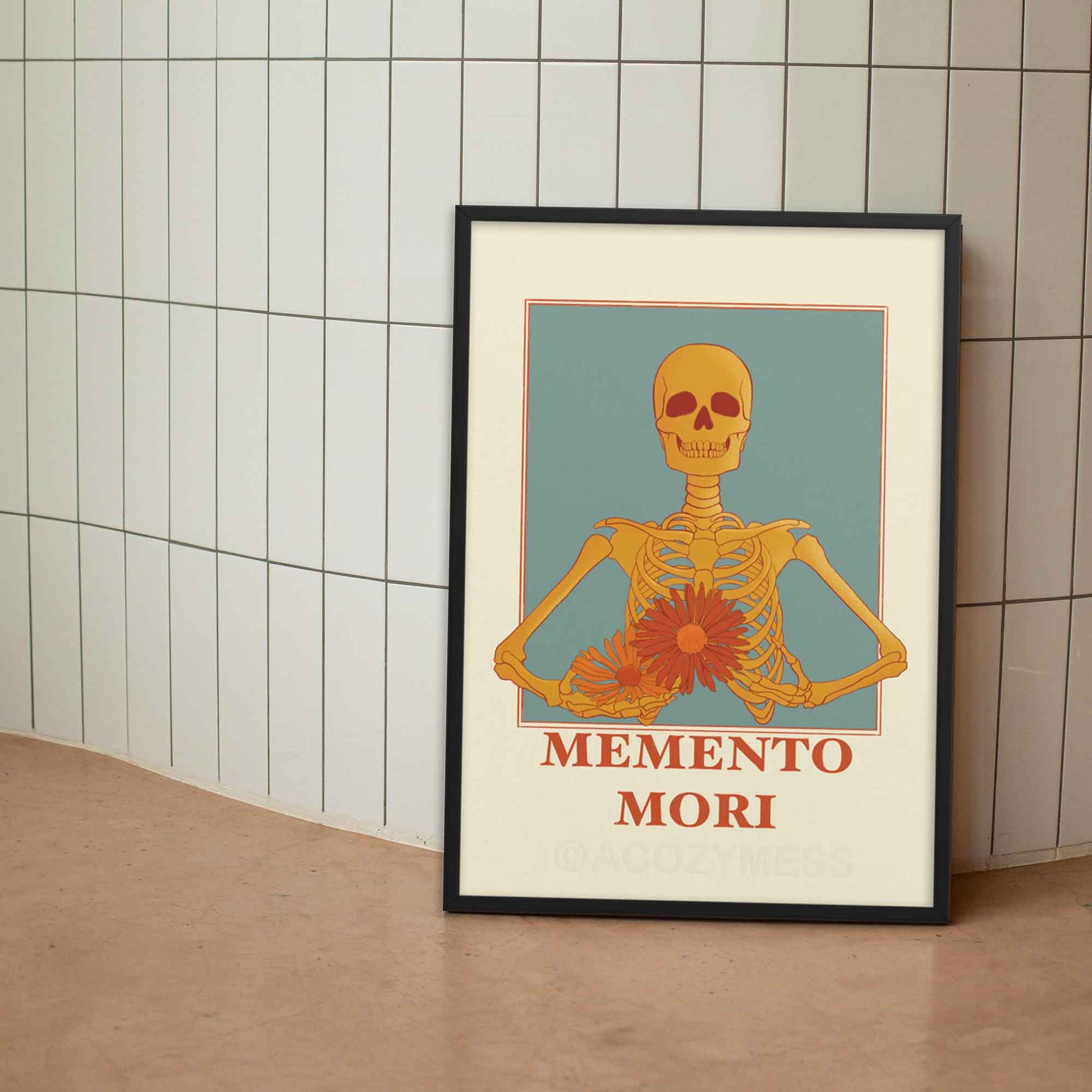 A memento mori art piece in beige blue, yellow & orange hues, featuring a skeleton carrying colorful flowers in black frame