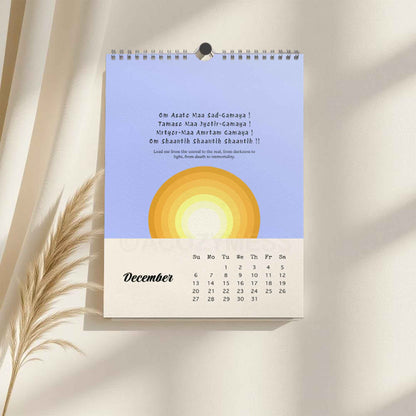 Wall calendar for December with a sun design on a light background