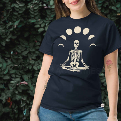 Woman wearing a navy blue t-shirt with a skeleton in a meditative pose design.