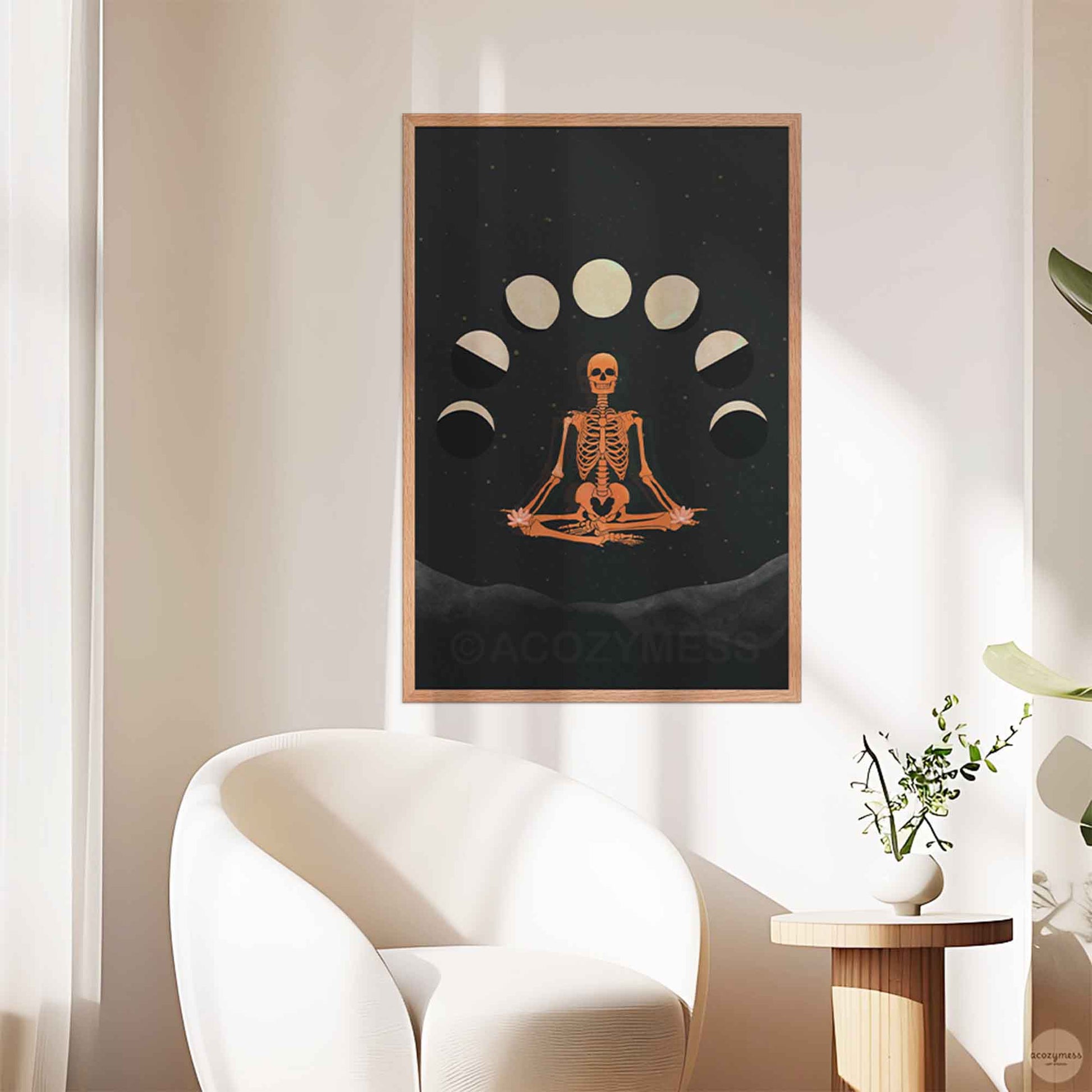 Meditating skeleton and moon phase poster framed in oakwood, creating a rustic yet mystical feel.