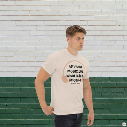 A man wearing natural color  t-shirt featuring the quote "Without music, life would be a mistake" by Friedrich Nietzsche in a playful, eye-catching font. 