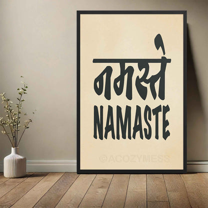 A vertical black-framed typography poster featuring the word Namaste in both Hindi (नमस्ते) and English, displayed in bold black font on a beige background. The minimalist design symbolizes peace, respect, and spiritual connection, making it ideal for yoga studios and mindful spaces.