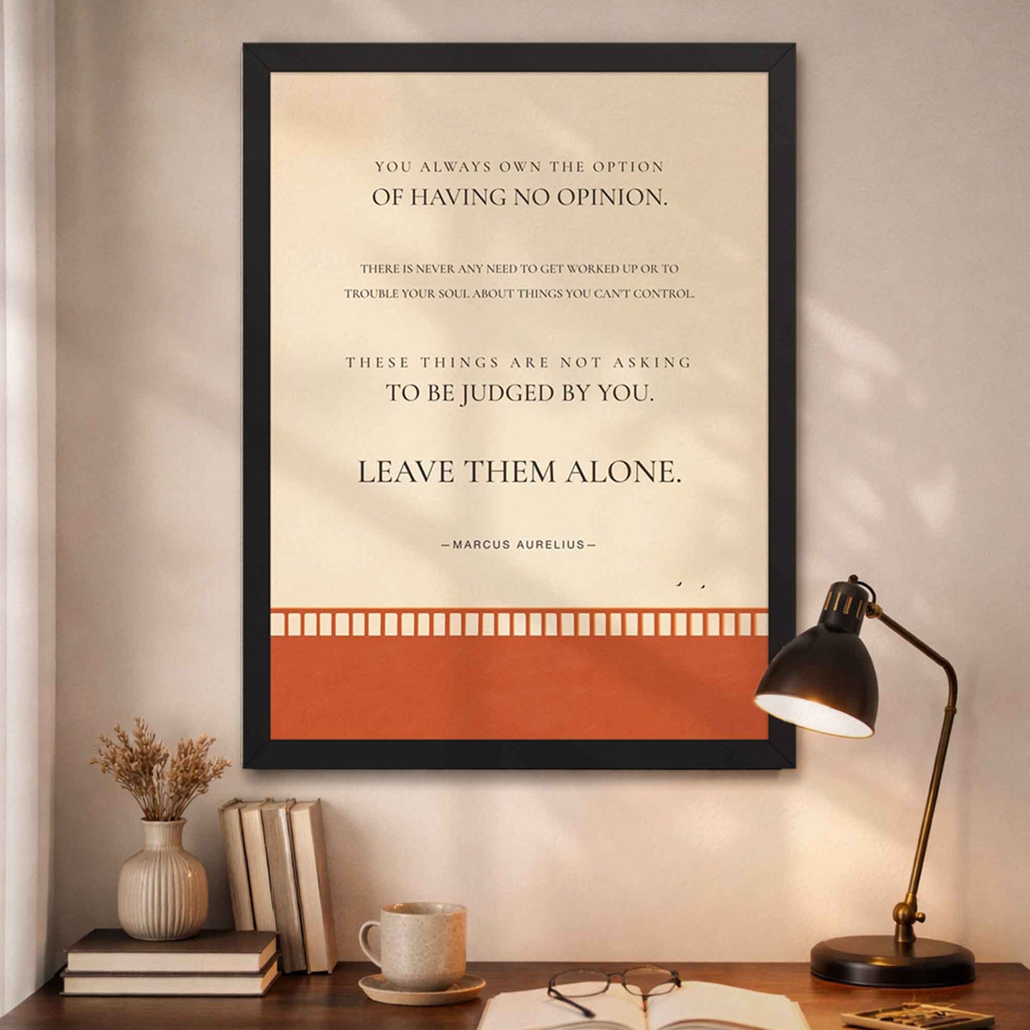 Modern Stoic quote wall art in black frame with orange bridge and birds in open sky