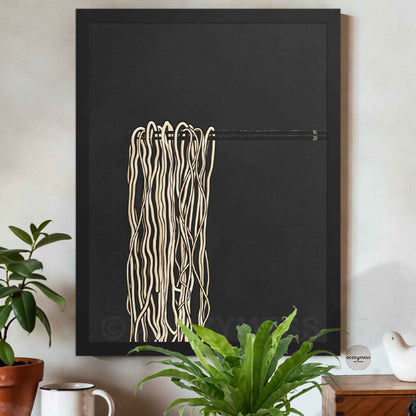 Black Framed abstract artwork with ramen noodles  art  on a black background, placed on a wall with plants and decor.