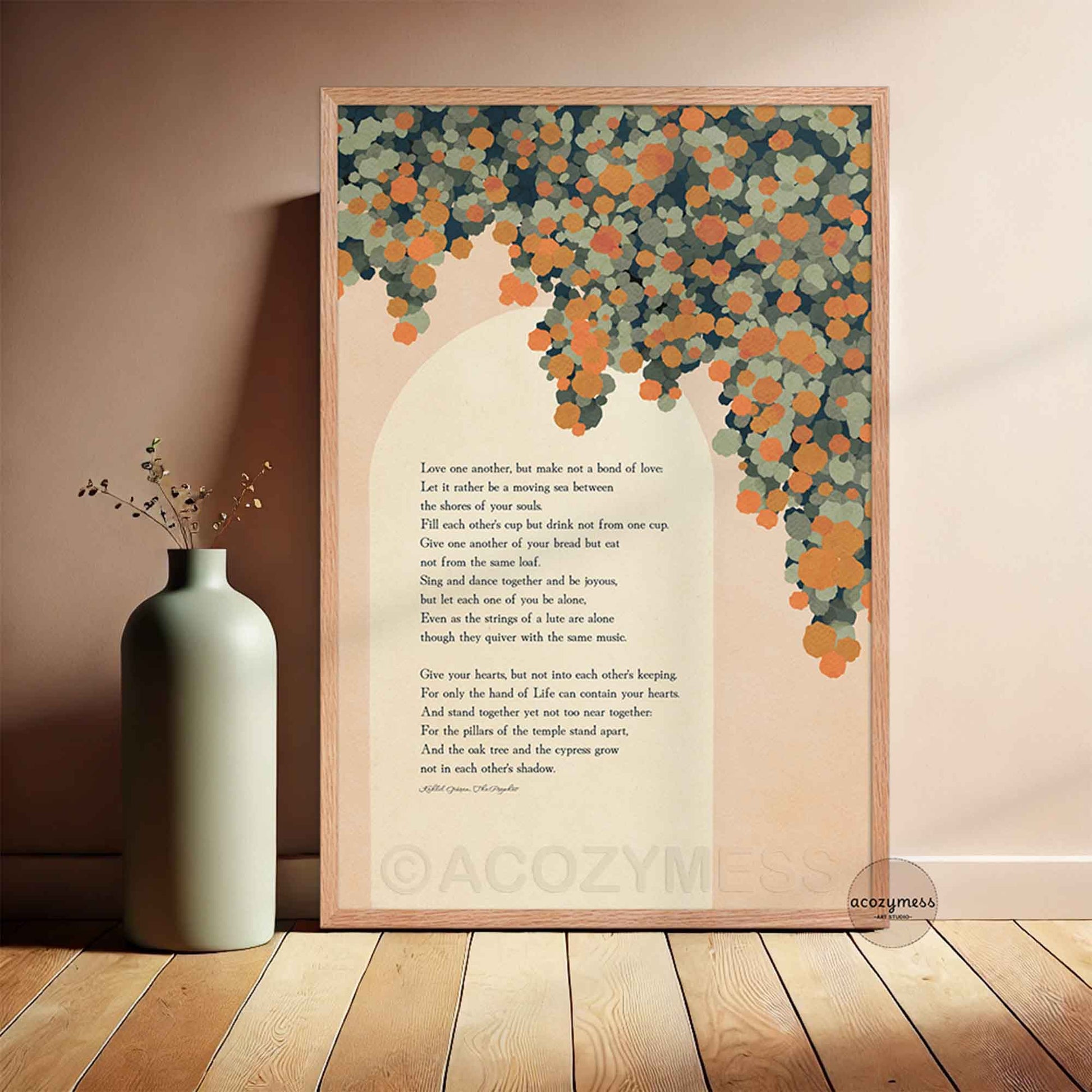 A framed vertical art print leaning against a beige wall, The print features a poem with a decorative background of orange florals on a cream backdrop, enclosed in a light wood frame.
