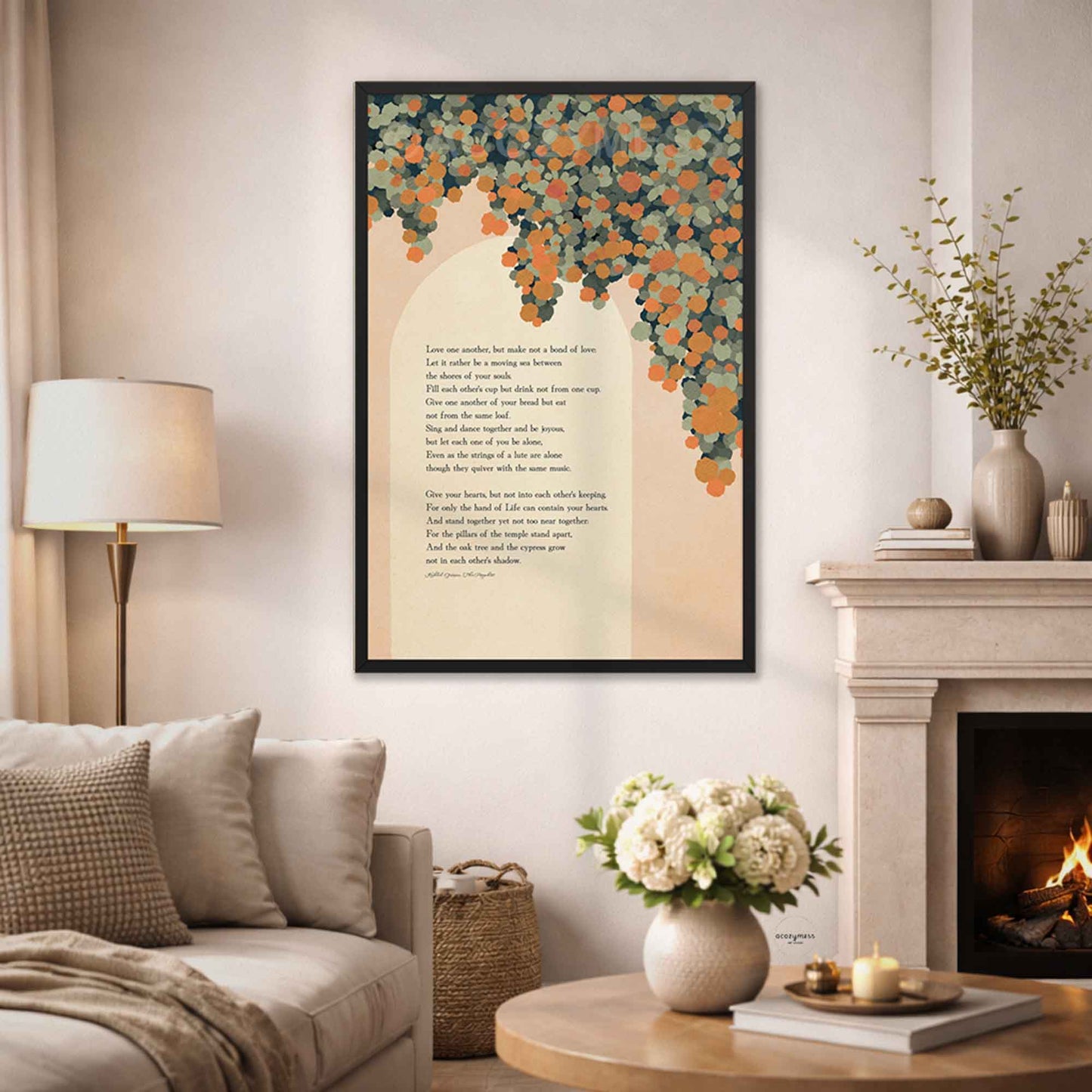 A black framed wall art print featuring a poem with an orange  floral canopy illustration, displayed in a cozy living room setting above a sofa next to a fireplace.