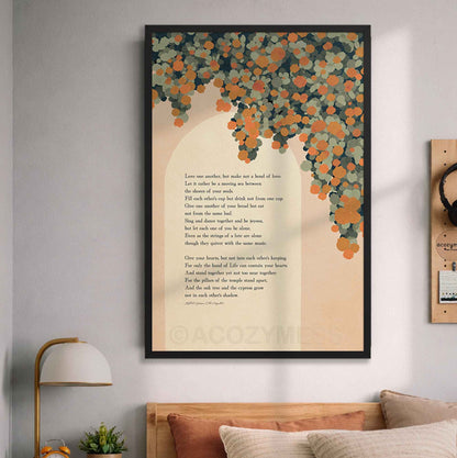 A black framed vertical wall art print hanging on a light gray wall above a bed. The artwork features a cream background with a love poem printed in black text and an illustration of orange vine flowers