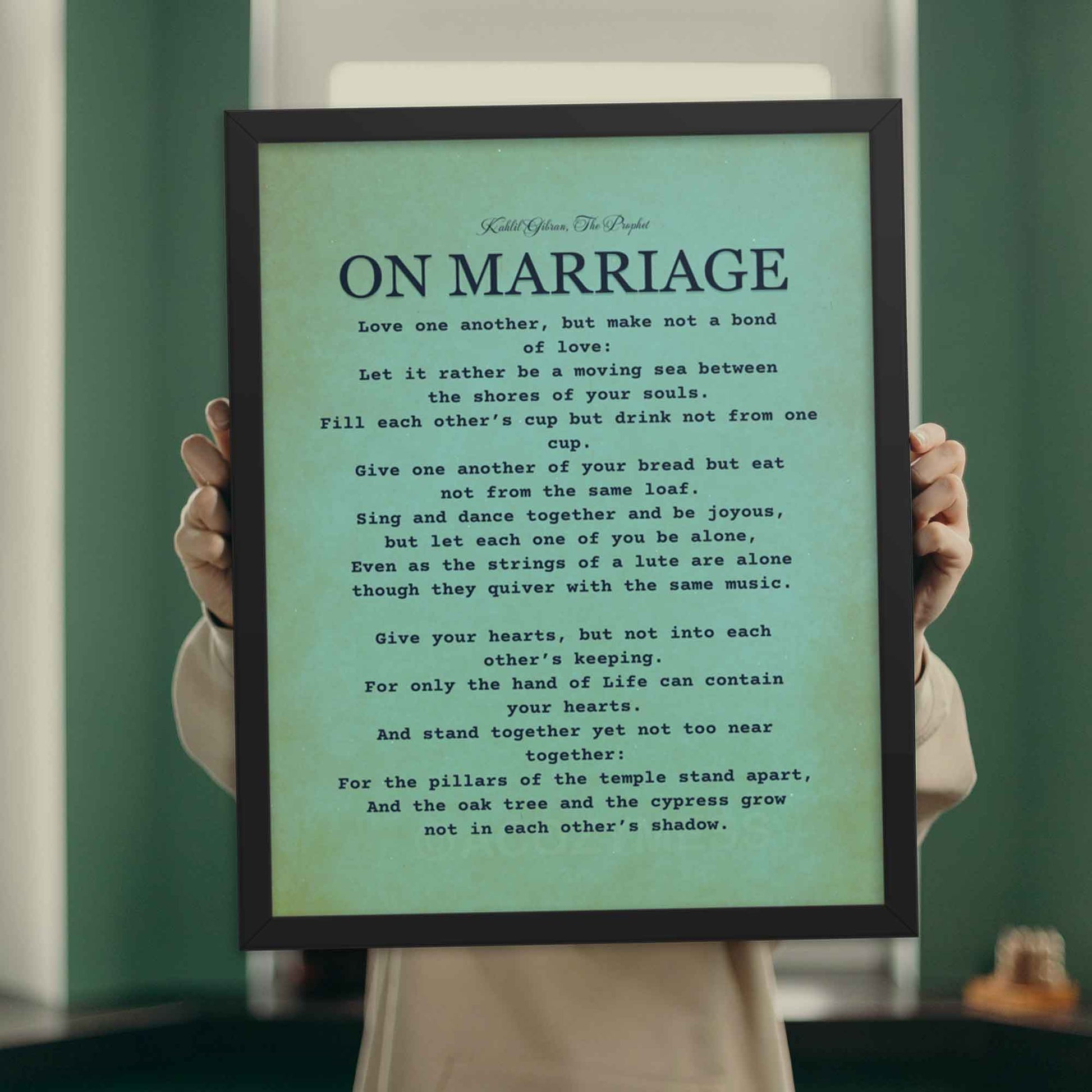 Kahlil Gibran Poster On Marriage, black on textured  bluish green background, displayed in black frame.