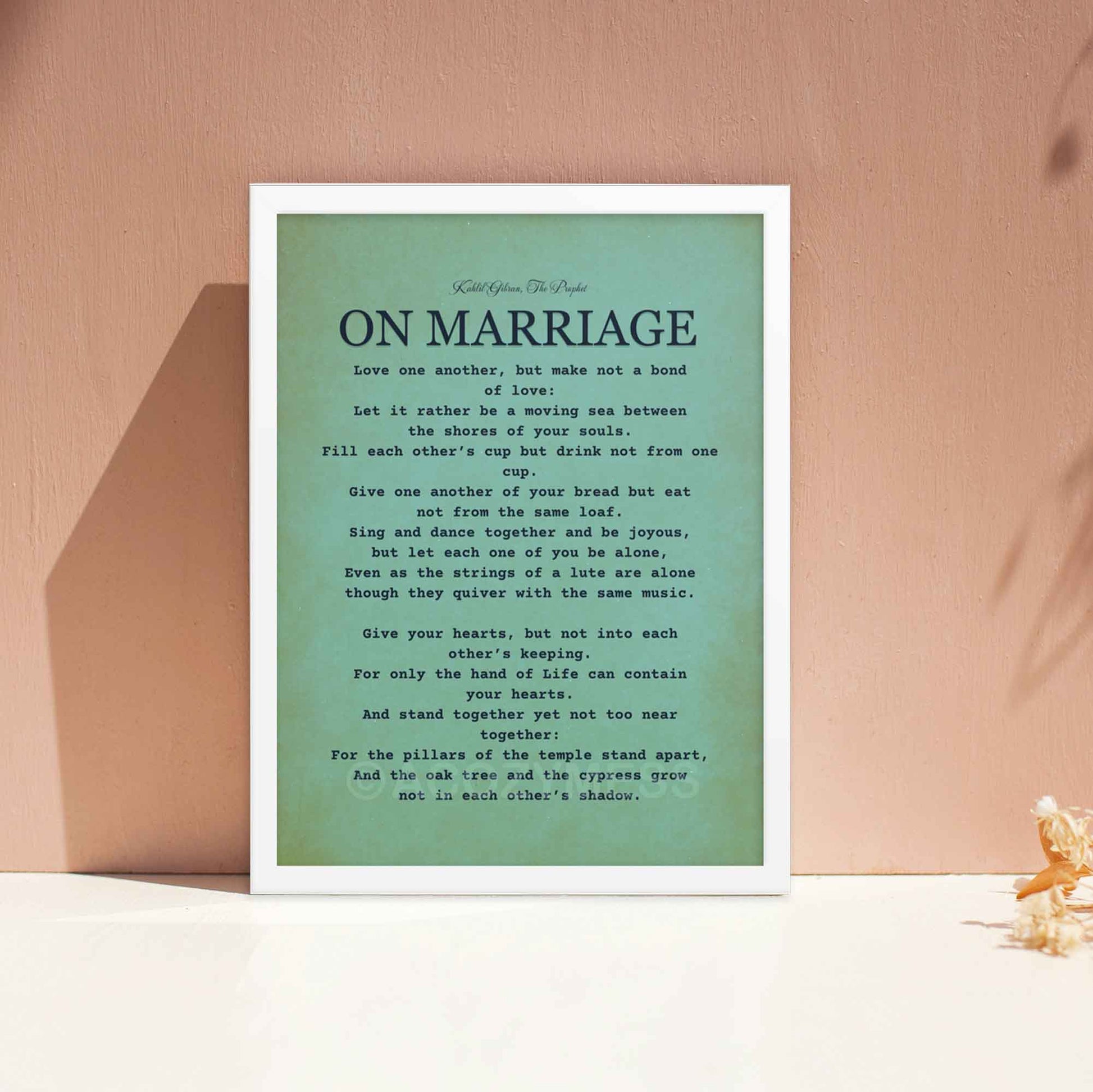 Kahlil Gibran Poster On Marriage, black on textured  bluish green background, displayed in white frame.