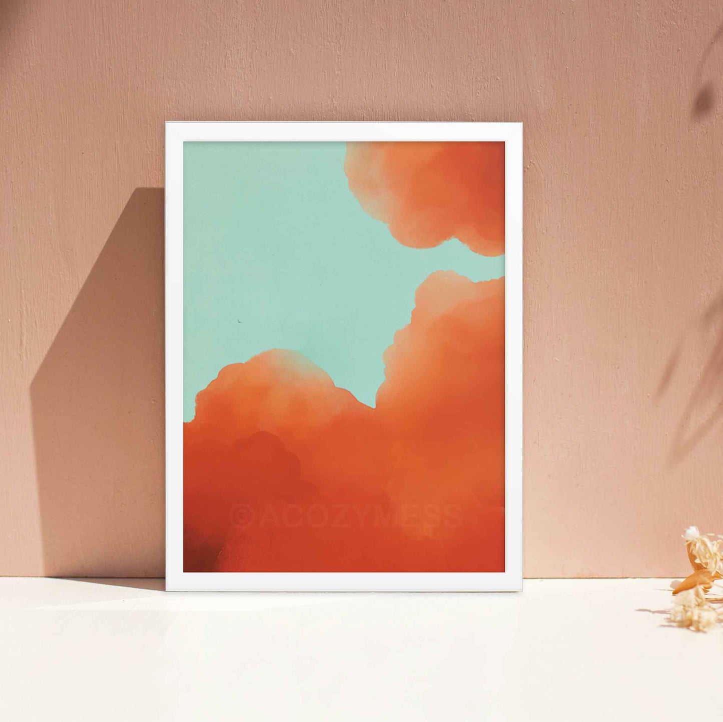 Illustrated art poster featuring vibrant orange-hued clouds against a serene blue sky in a white frame