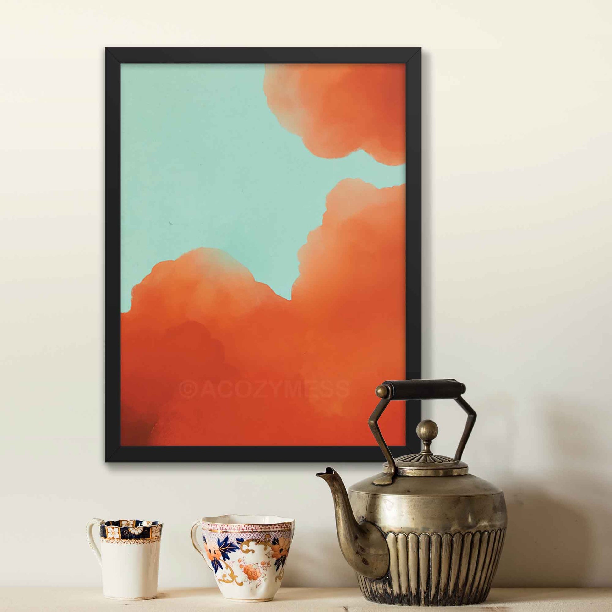 Illustrated  poster featuring vibrant orange-hued clouds against a serene blue sky in black frame.