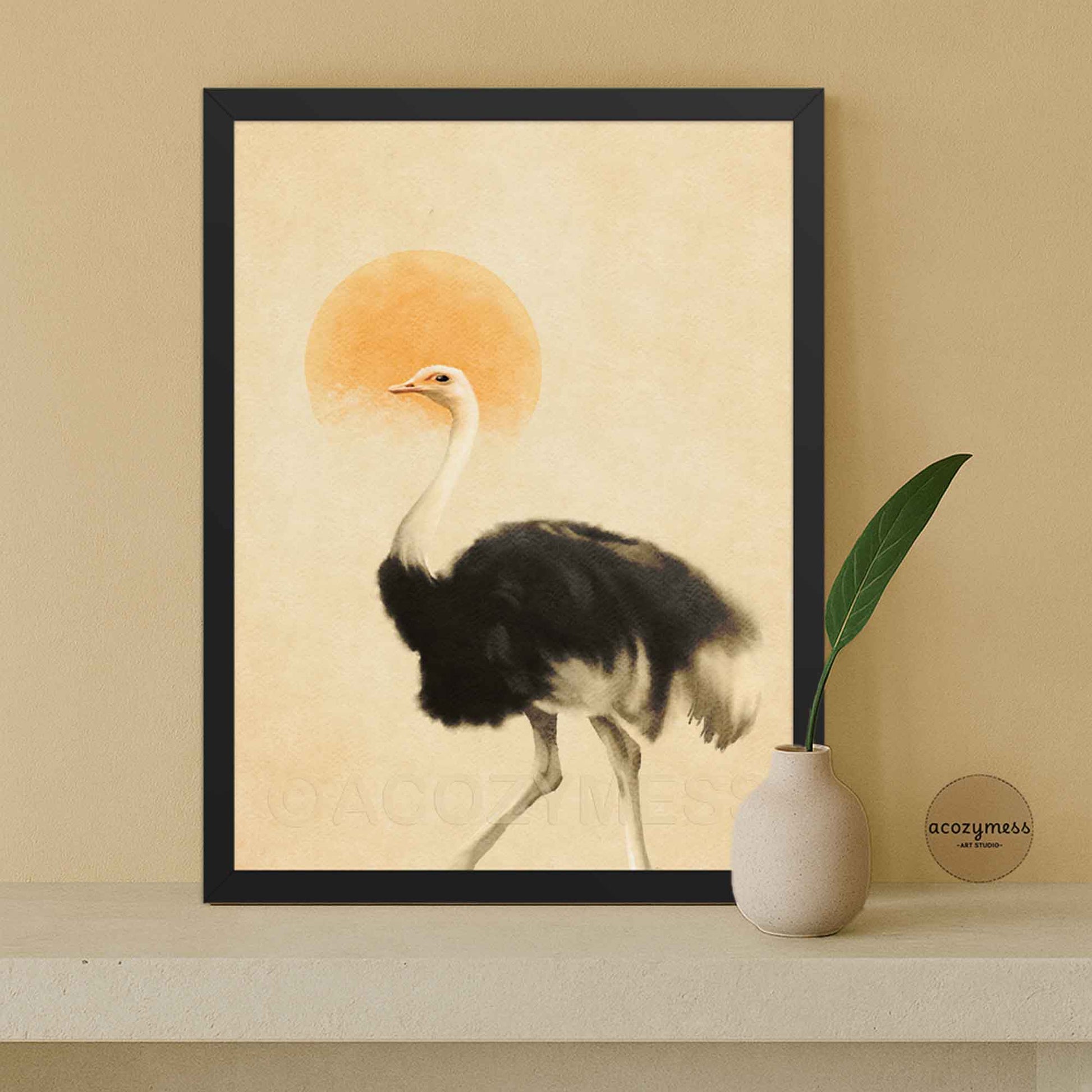 A framed art print featuring a black and white ostrich with a warm orange sun on a beige background.
