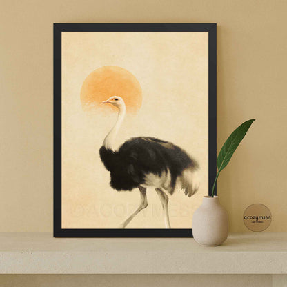 A framed art print featuring a black and white ostrich with a warm orange sun on a beige background.