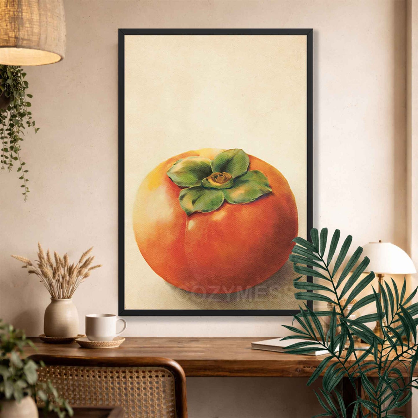 Black Framed artwork of a persimmon fruit on a wall above a wooden console table.