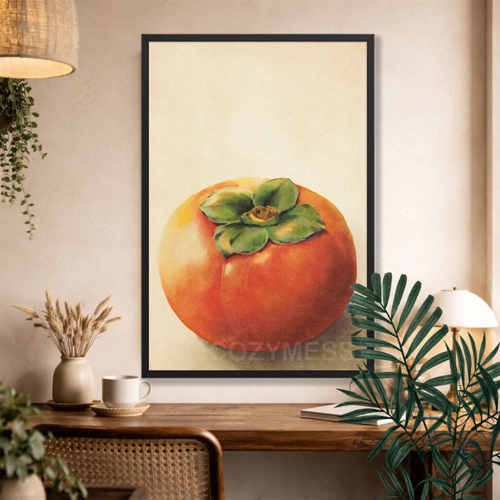 Black Framed artwork of a persimmon fruit on a wall above a wooden console table.