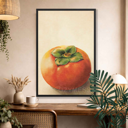 Black Framed artwork of a persimmon fruit on a wall above a wooden console table.