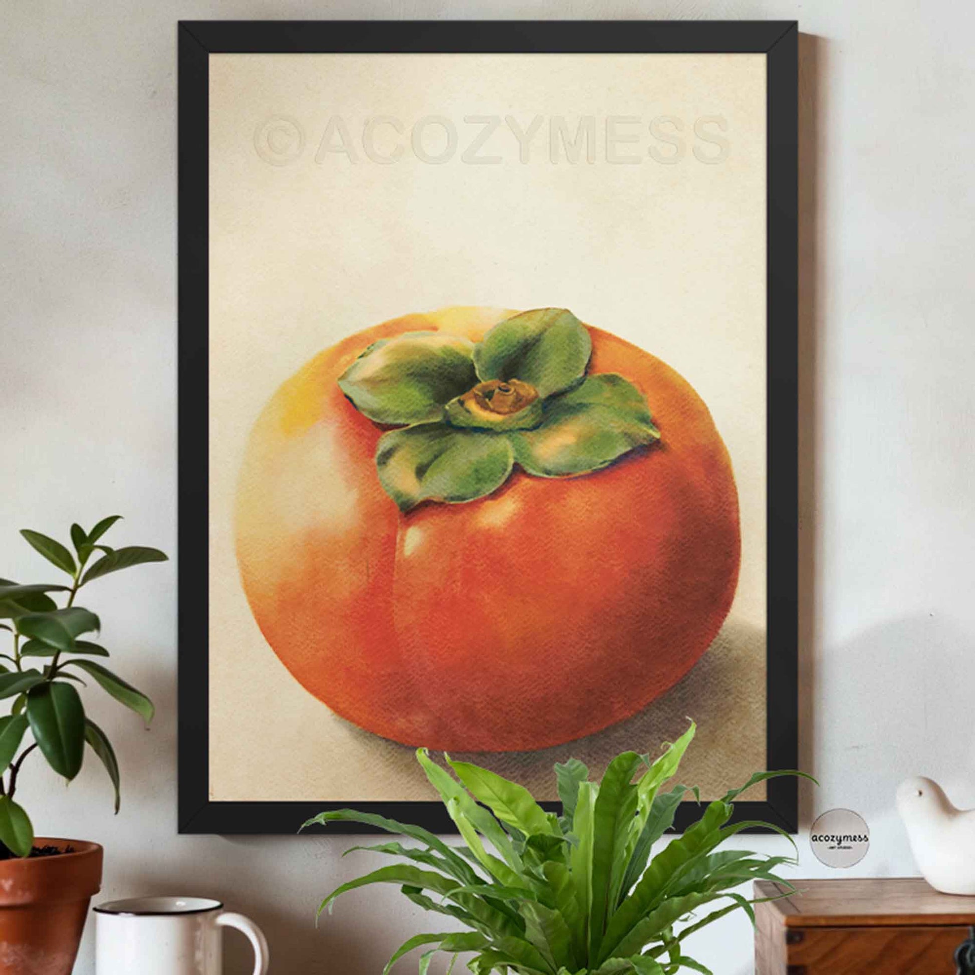 Black Framed artwork of a persimmon fruit  on beige background on a wall.