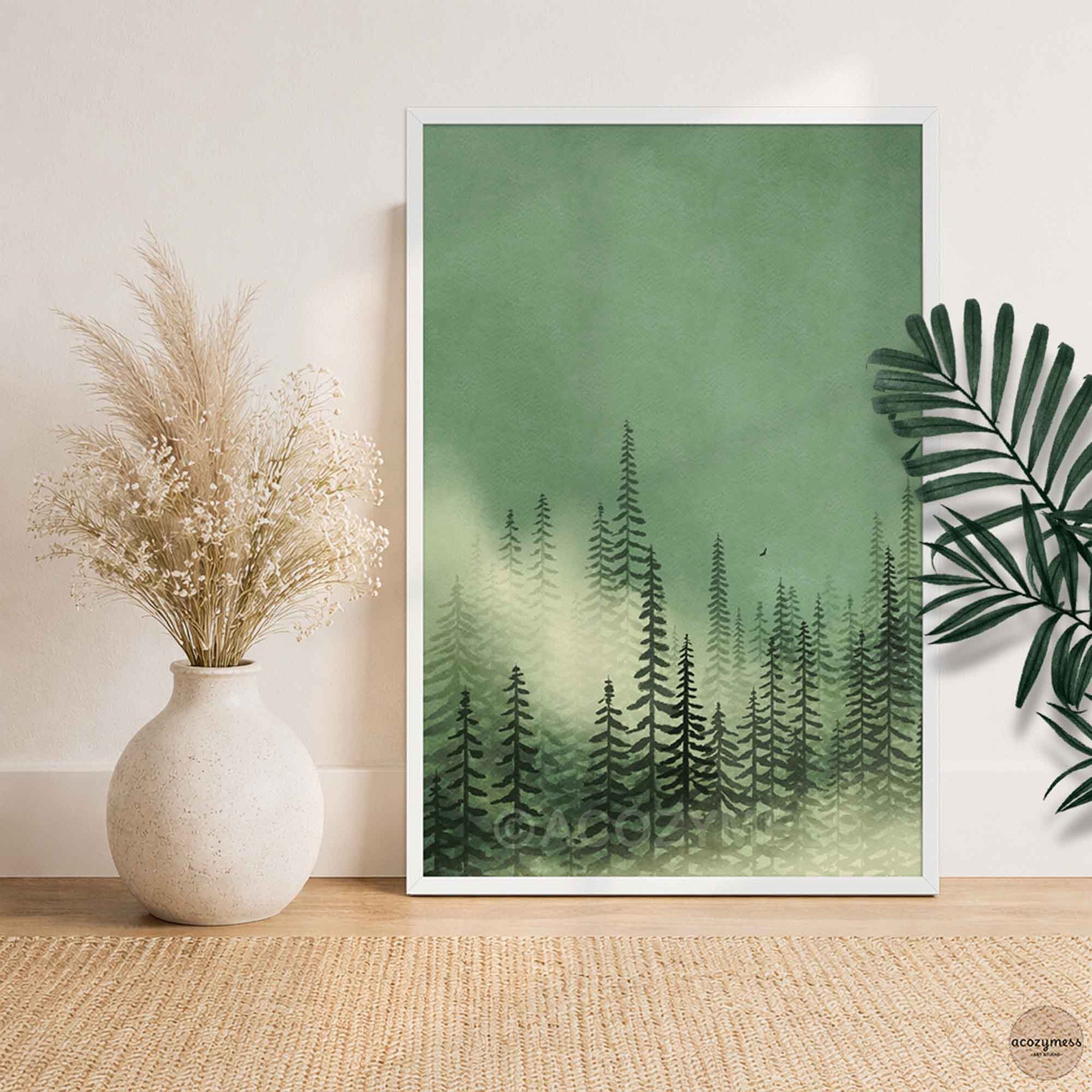 Misty green pine forest wall art in white frame styled in bright modern interior