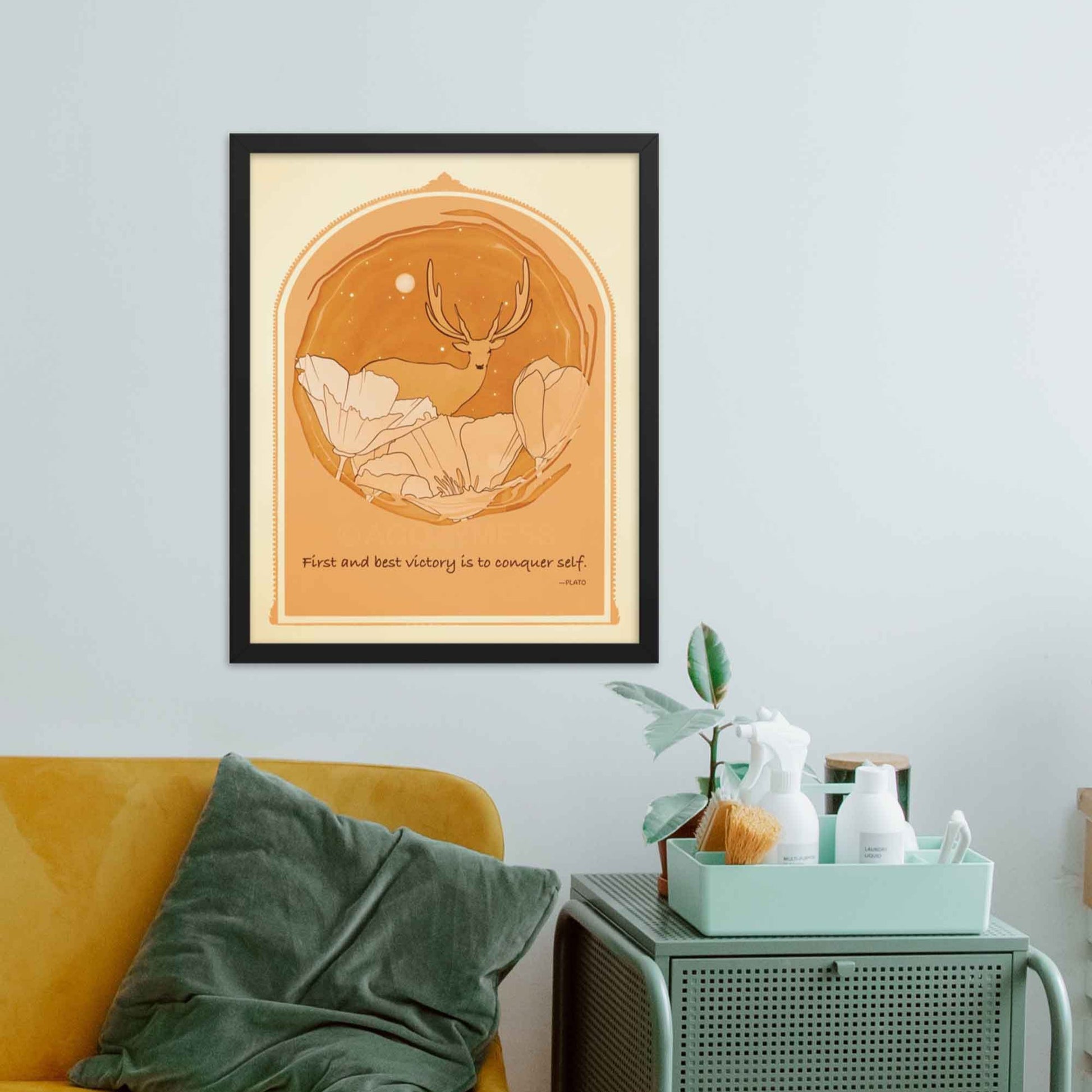 Art print featuring Plato's quote 'The first and best victory is to conquer self' alongside an illustration of a deer among flowers, done in yellow, orange and brown, framed in black