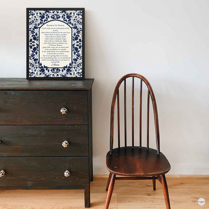 Prayer of St. Francis poster shown in a clean black frame, with elegant dark blue floral accents on a  light beige background for prayer room