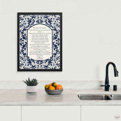 Prayer of St. Francis poster shown in a clean black frame, with elegant dark blue floral accents on a  light beige background for positive faith based decor.