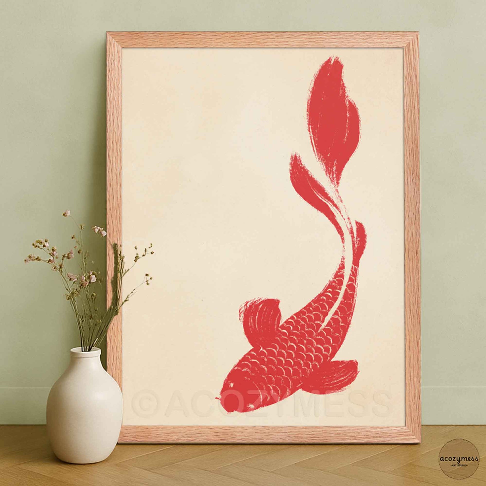 Framed artwork of a red fish on a beige background.