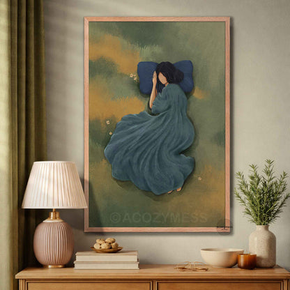 Oak  frame showcasing a  art print of a serene woman resting in an olive green meadow draped in a flowing blue gown, displayed in a cozy room setting.