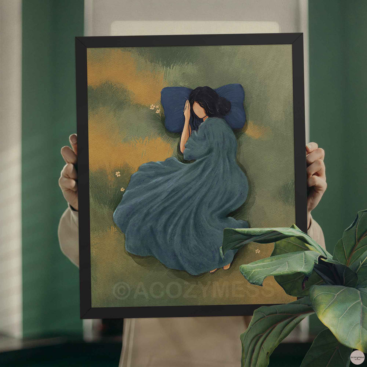 black framed art poster of a woman sleeping peacefully in a green grassy meadow with a blue pillow depicting slow life.