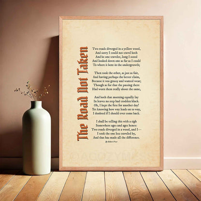 A vintage-style poster featuring Robert Frost’s iconic poem "The Road Not Taken" printed on an aged, old-paper background, i an oakwood frame.