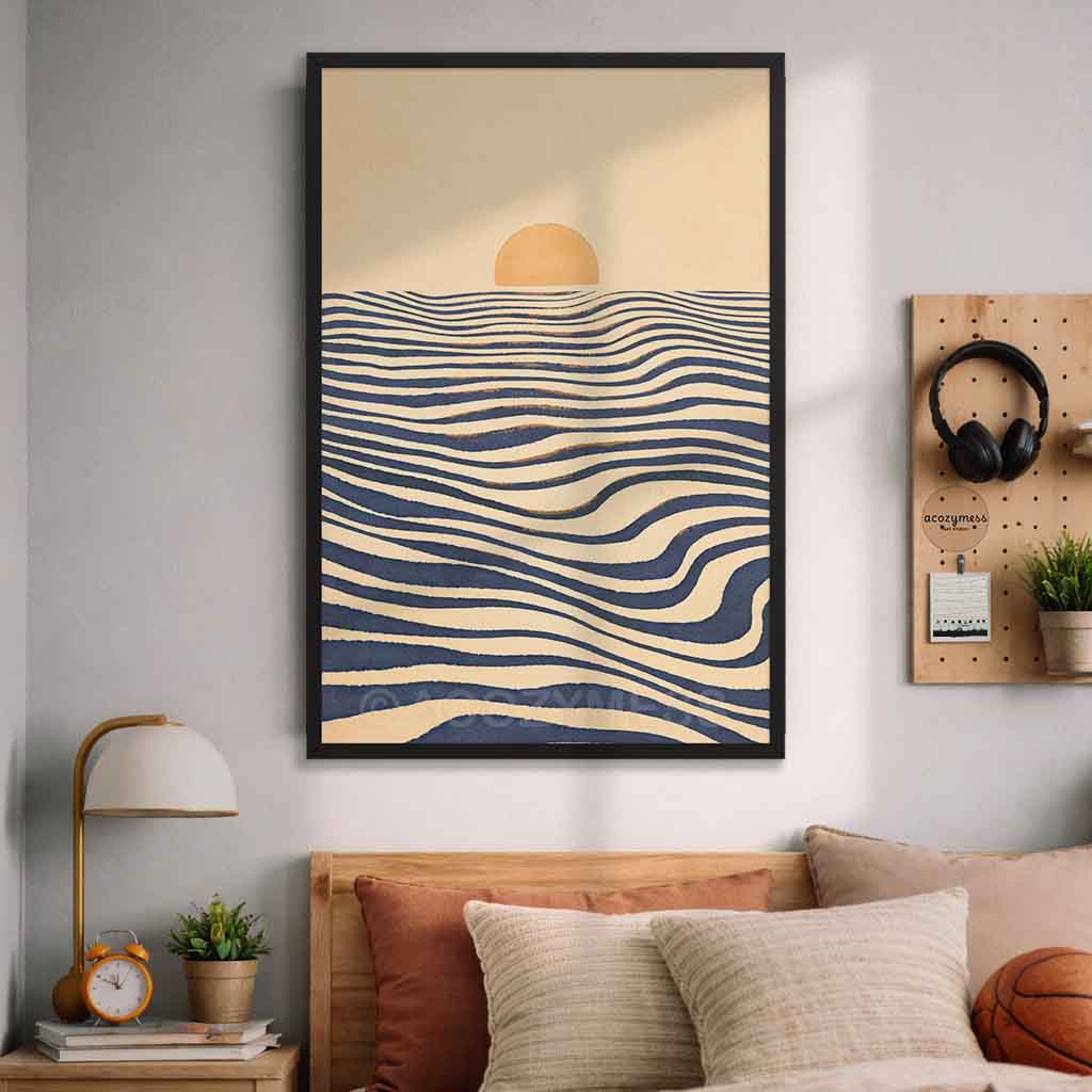 A black  framed wall art print featuring a minimalist abstract  landscape with sea and a sun, displayed above a bed in a styled bedroom setting.