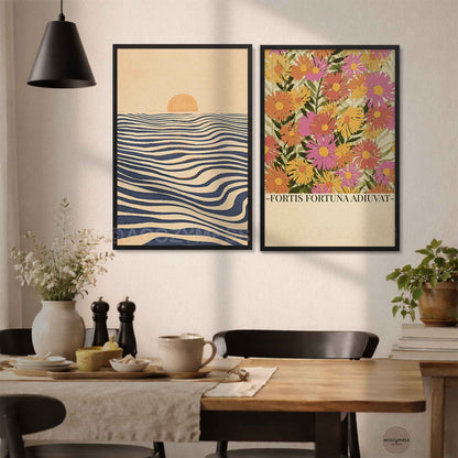 Two framed wall art prints displayed above a wooden dining table in a styled interior. The left print shows a minimalist sunset over wavy blue and beige lines, and the right print features a colorful floral design with the Latin phrase 'FORTIS FORTUNA ADIVIVAT'.