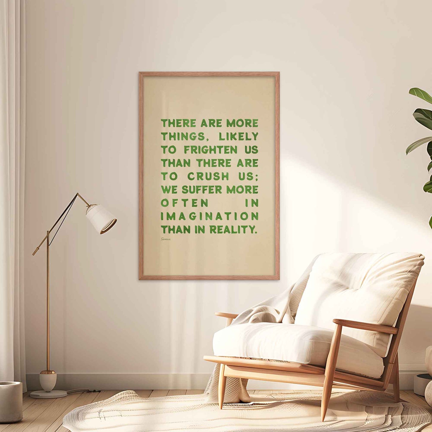 Seneca Poster with quote on fear, green on beige, displayed in oakwood frame on a  wall.