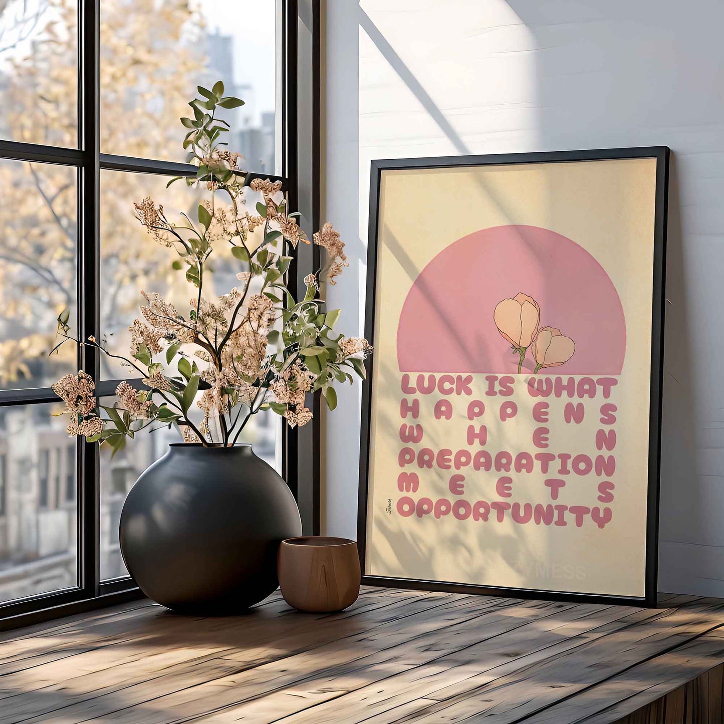 Seneca print with the quote, Luck is what happens when preparation meets opportunity, in pink and beige with a delicate floral design, displayed in a black frame. 