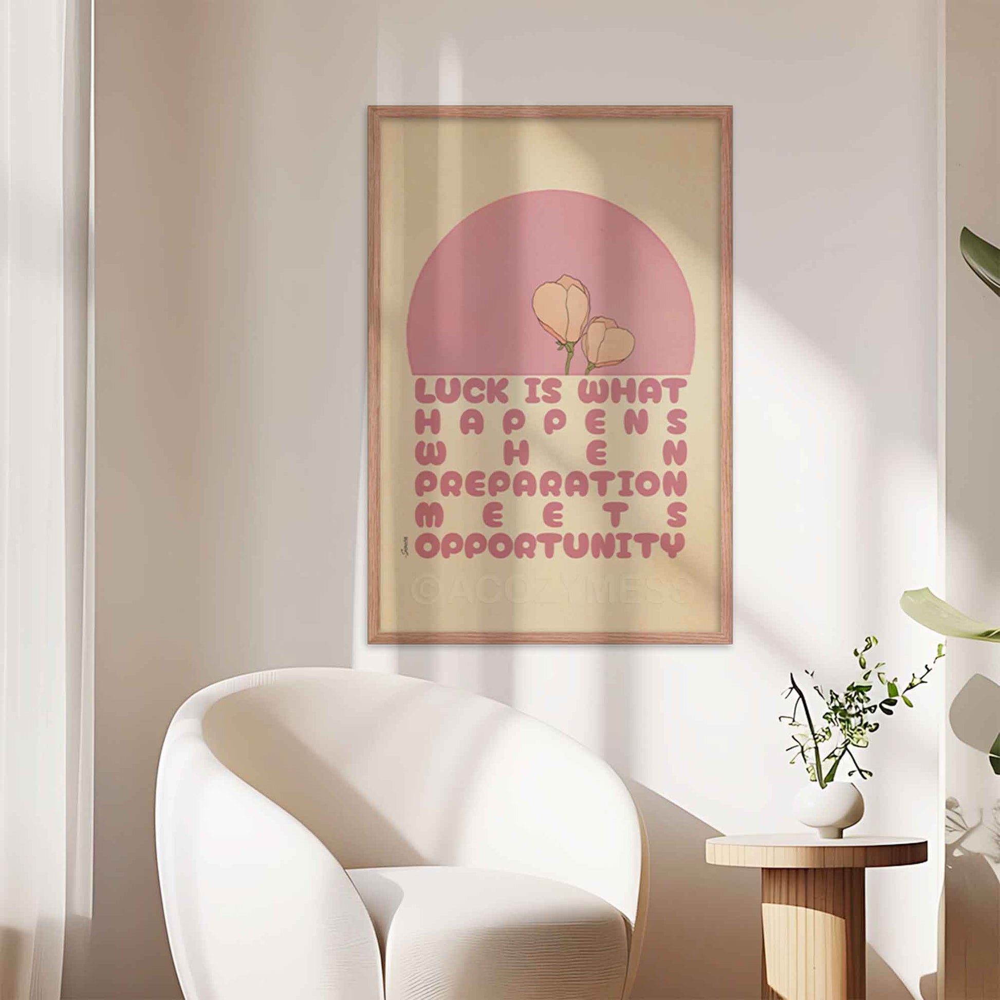 Seneca poster with the quote, Luck is what happens when preparation meets opportunity, in pink and beige with a delicate floral design, displayed in a oakwood frame. 