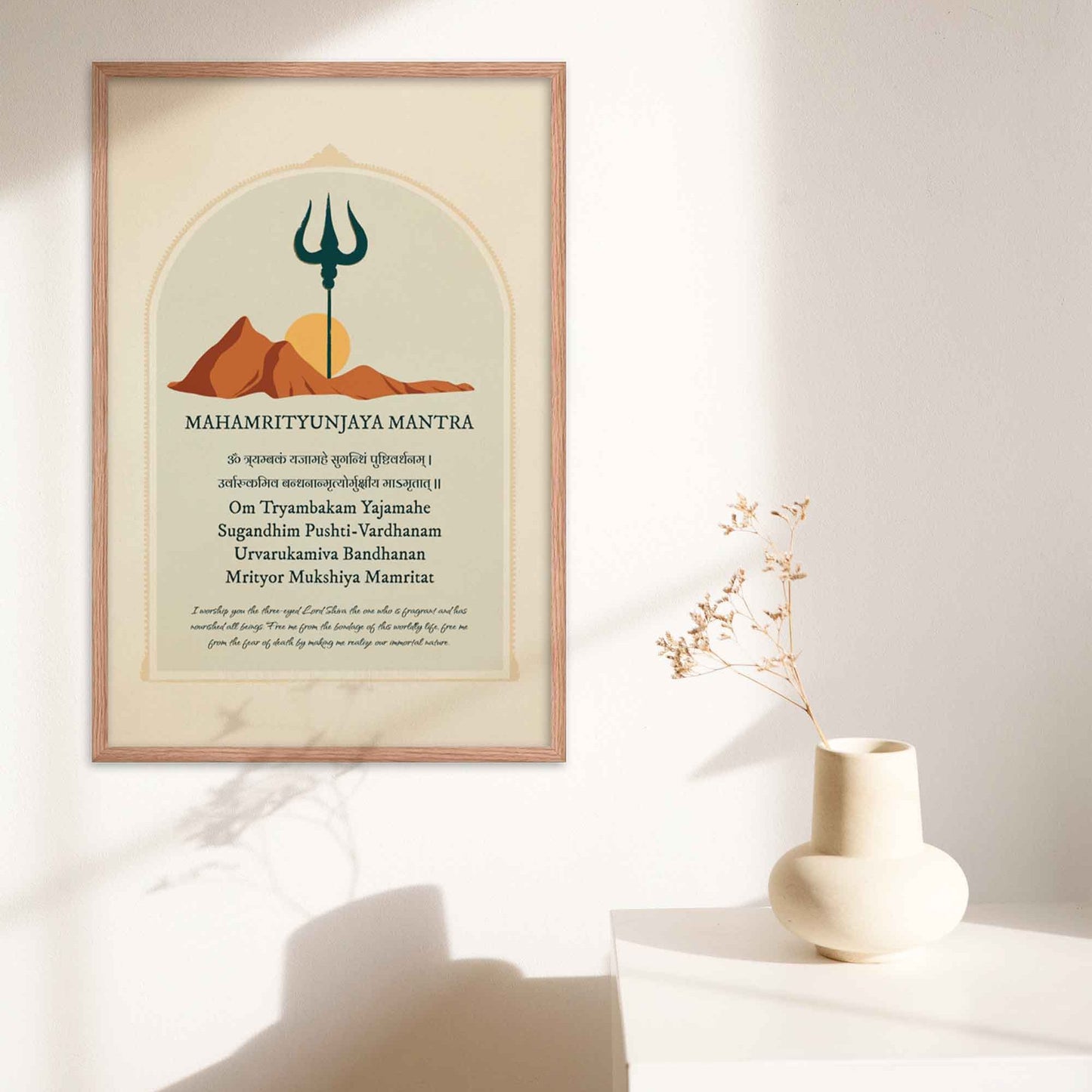 Art print featuring the Mahamrityunjaya Mantra in Sanskrit and English with its meaning, alongside an illustration of mountains, the sun, and a trishul, symbolizing the deity Shiva, in oakwood frame.