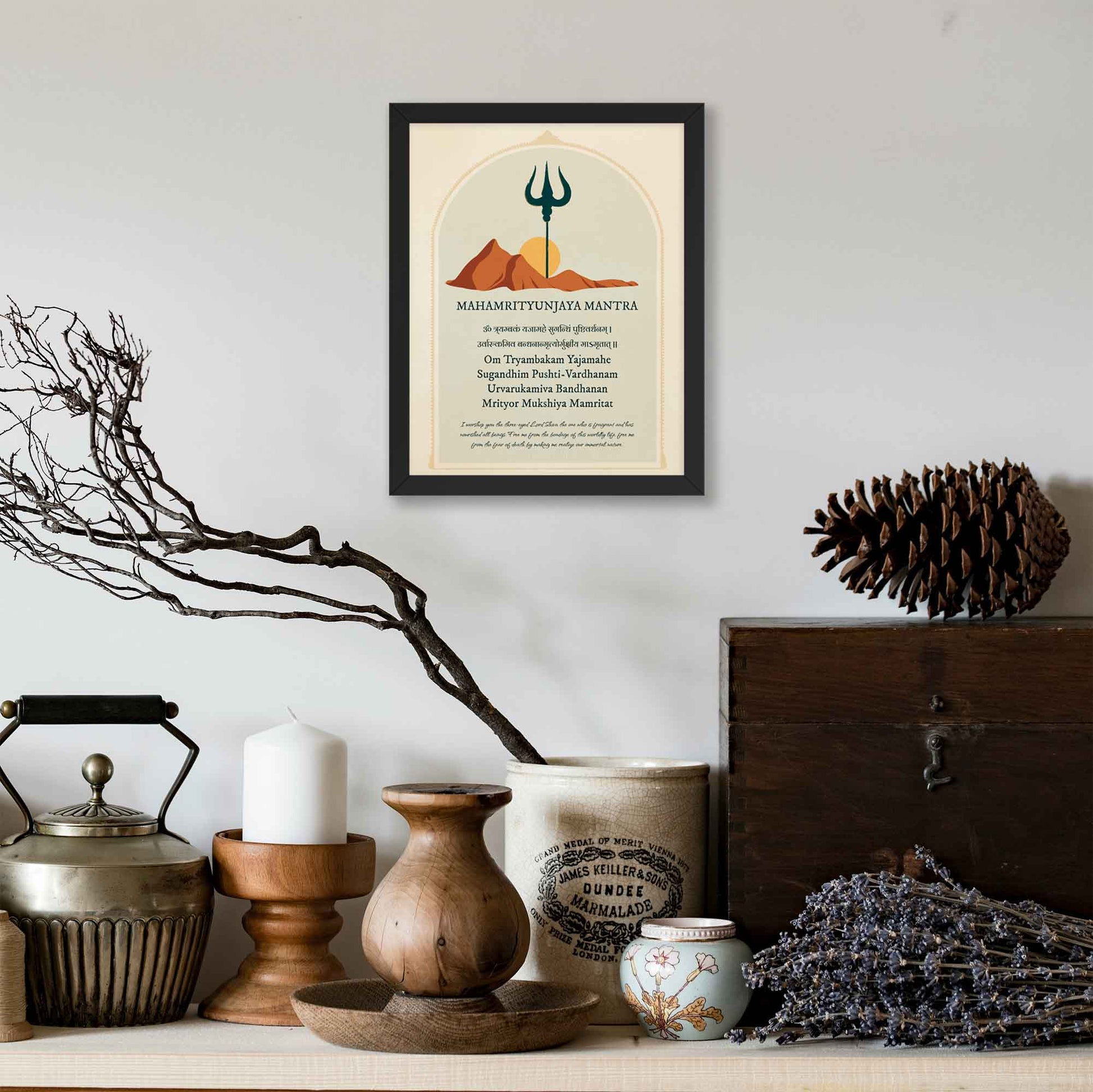 Art print featuring the Mahamrityunjaya Mantra in Sanskrit and English with its meaning, alongside an illustration of mountains, the sun, and a trishul, symbolizing the deity Shiva,framed in black.