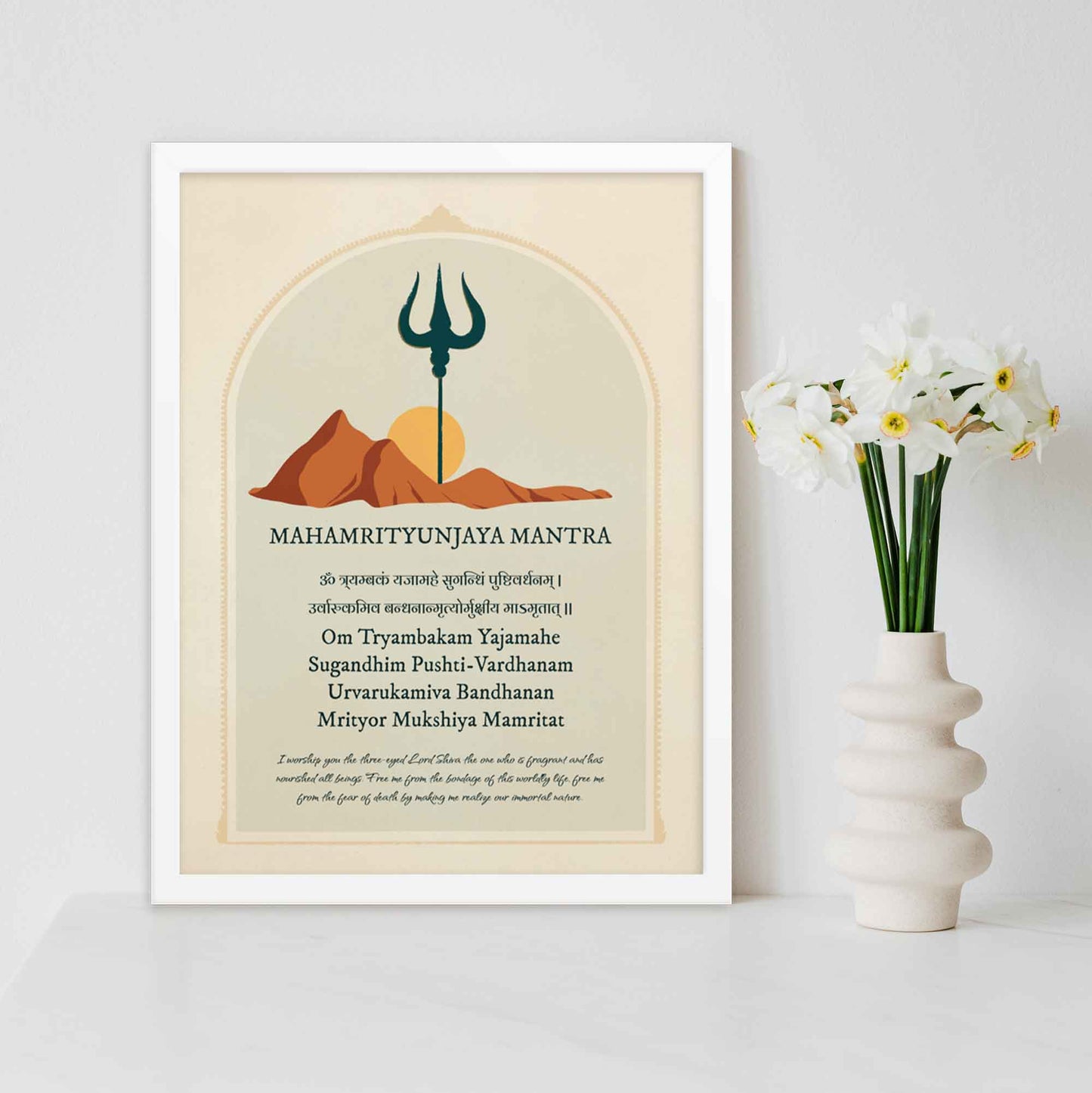 Art print featuring the Mahamrityunjaya Mantra in Sanskrit and English with its meaning, alongside an illustration of mountains, the sun, and a trishul, symbolizing the deity Shiva, in white frame.