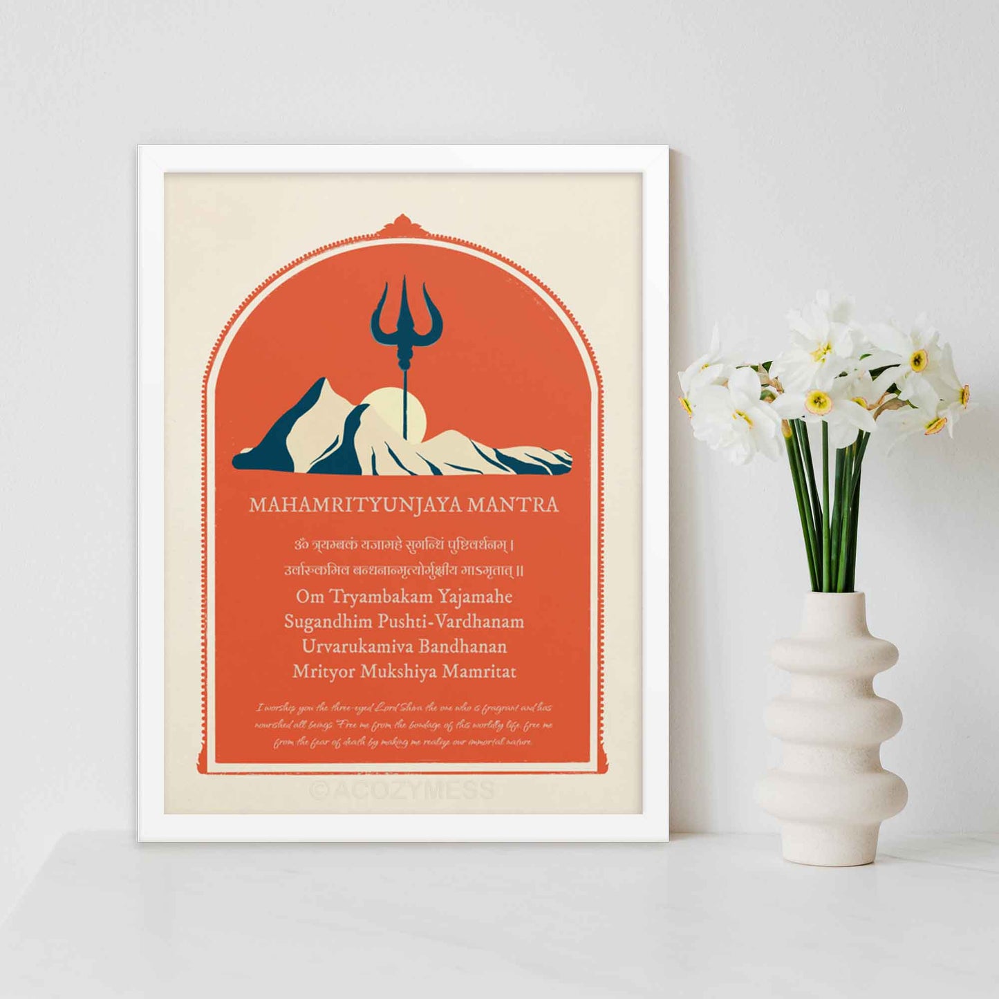 MahaMritunjaya mantra poster with mountain and trishul illustration symbolizing shiva in red, biege and blue, in white frame.