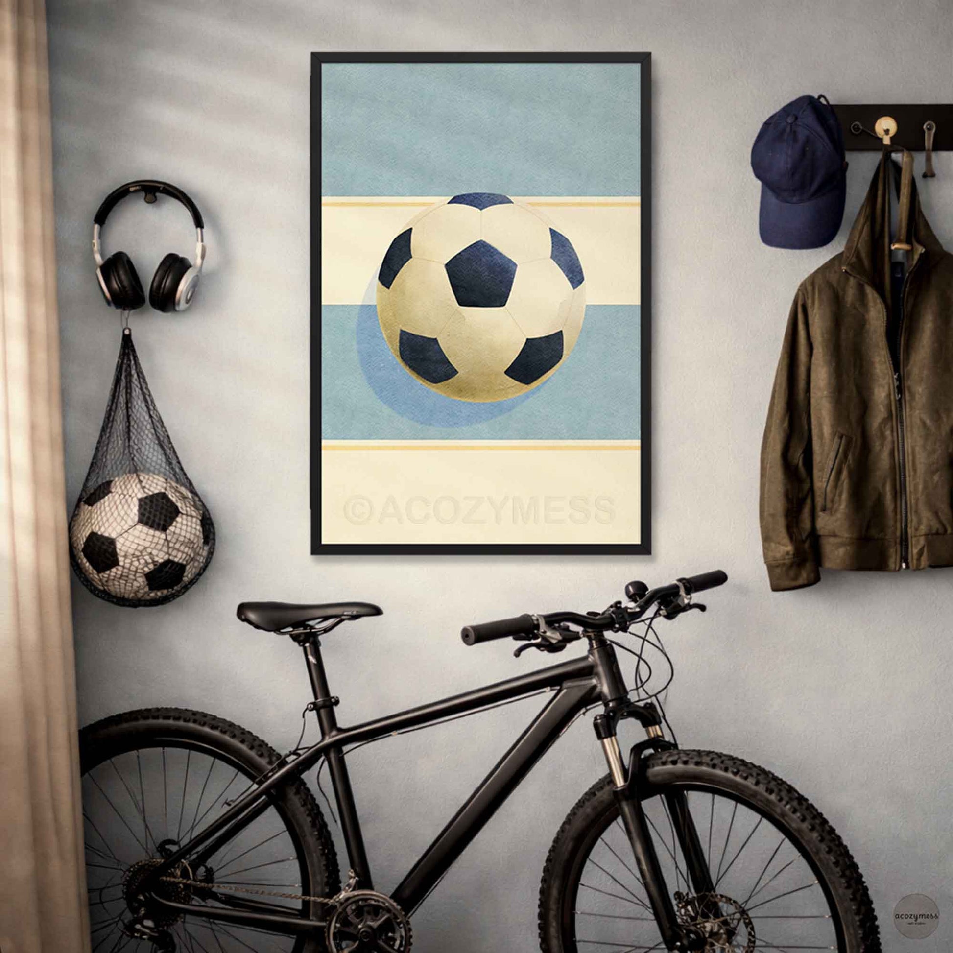 Contemporary soccer wall art in black frame—soccer ball illustration on a light blue and beige background.