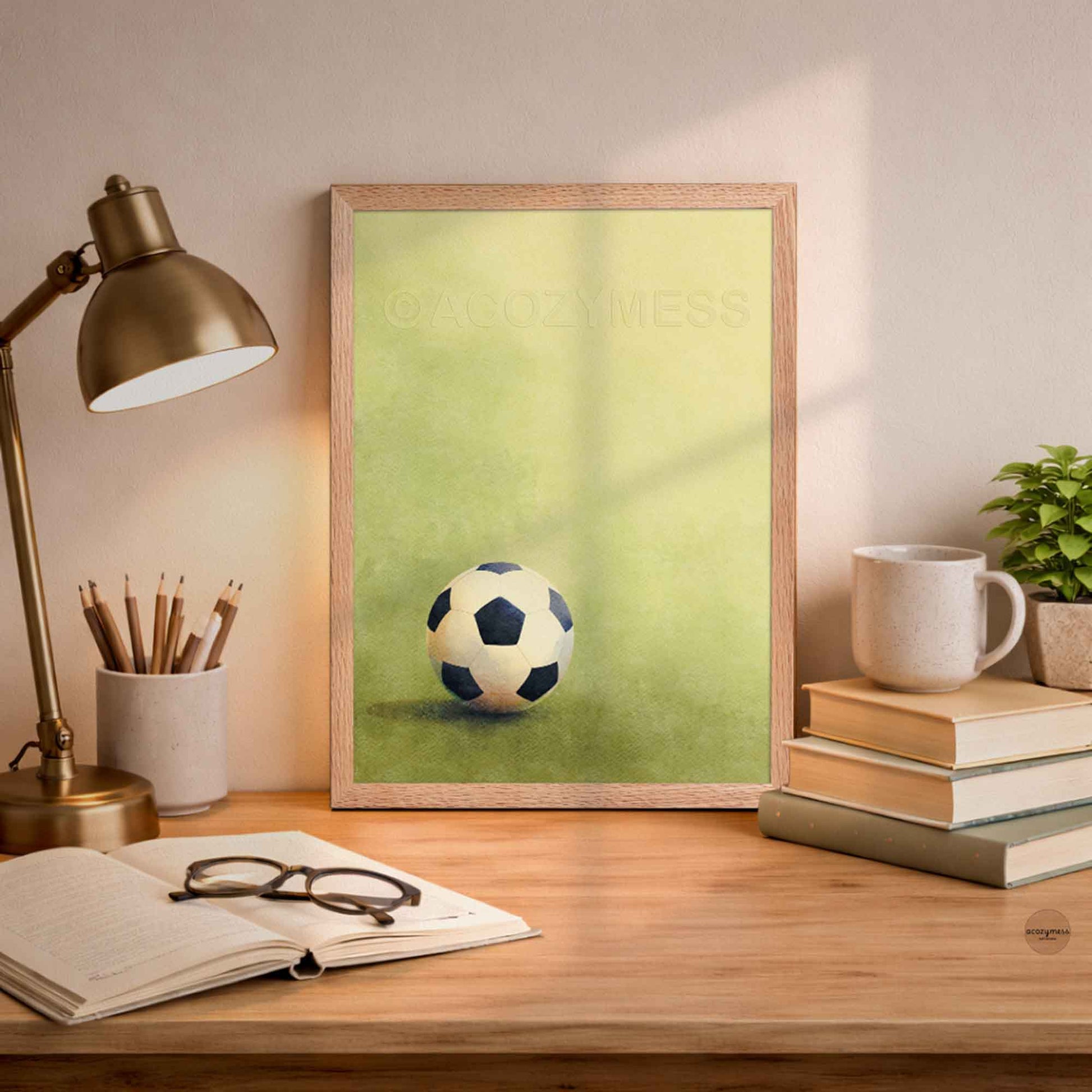 Oak Framed picture of a soccer ball on a desk.