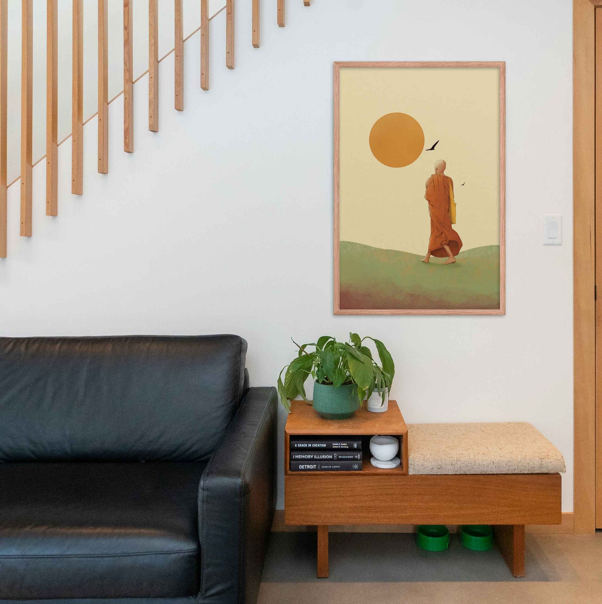 Wall art featuring a monk walking towards the sun, symbolizing the journey towards inner peace and enlightenment in earthly hues of green ywellow and orange on beige background framed in oakwood