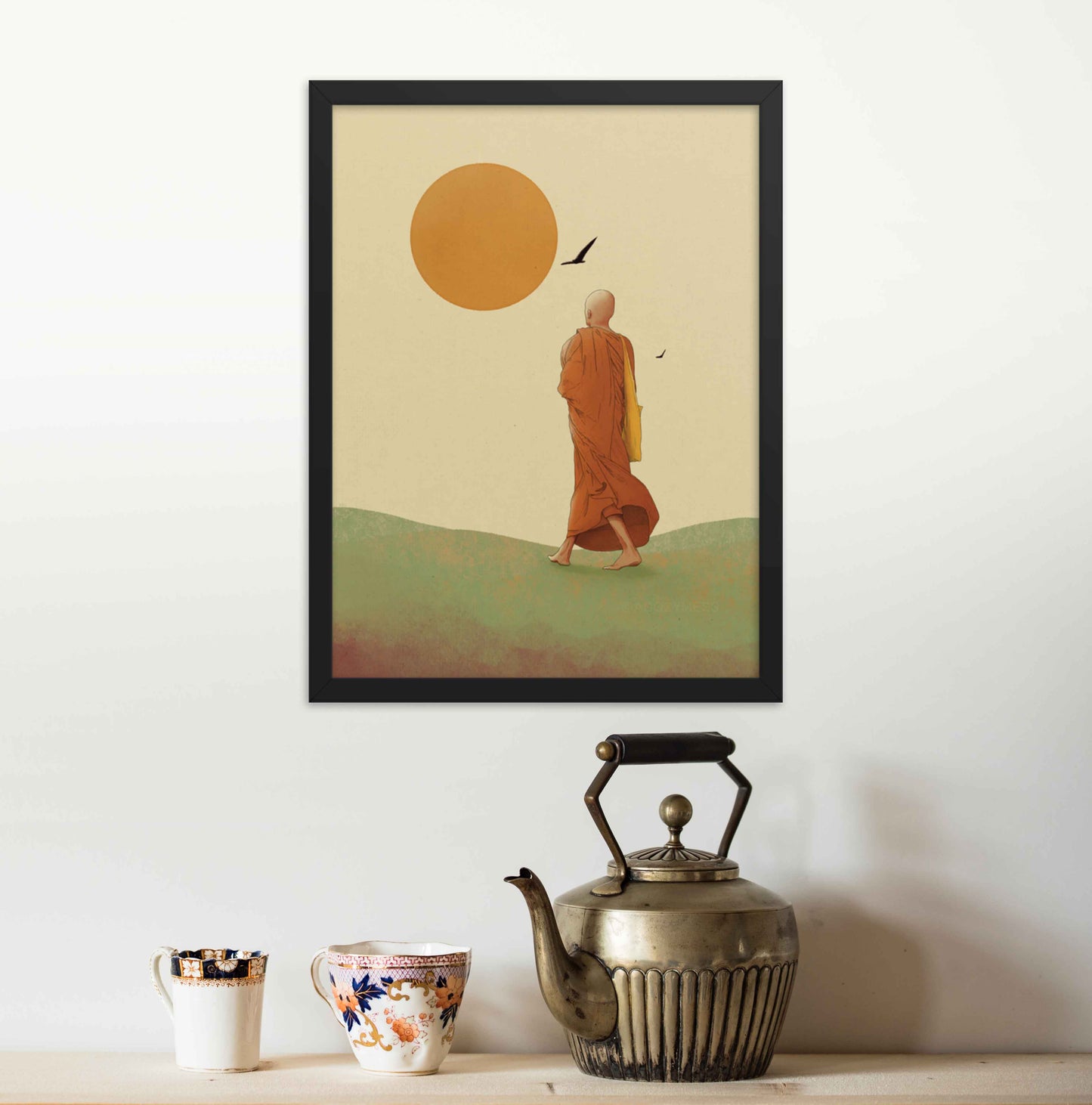 Wall art featuring a monk walking towards the sun, symbolizing the journey towards inner peace and enlightenment in earthly hues of green ywellow and orange on beige background framed in black