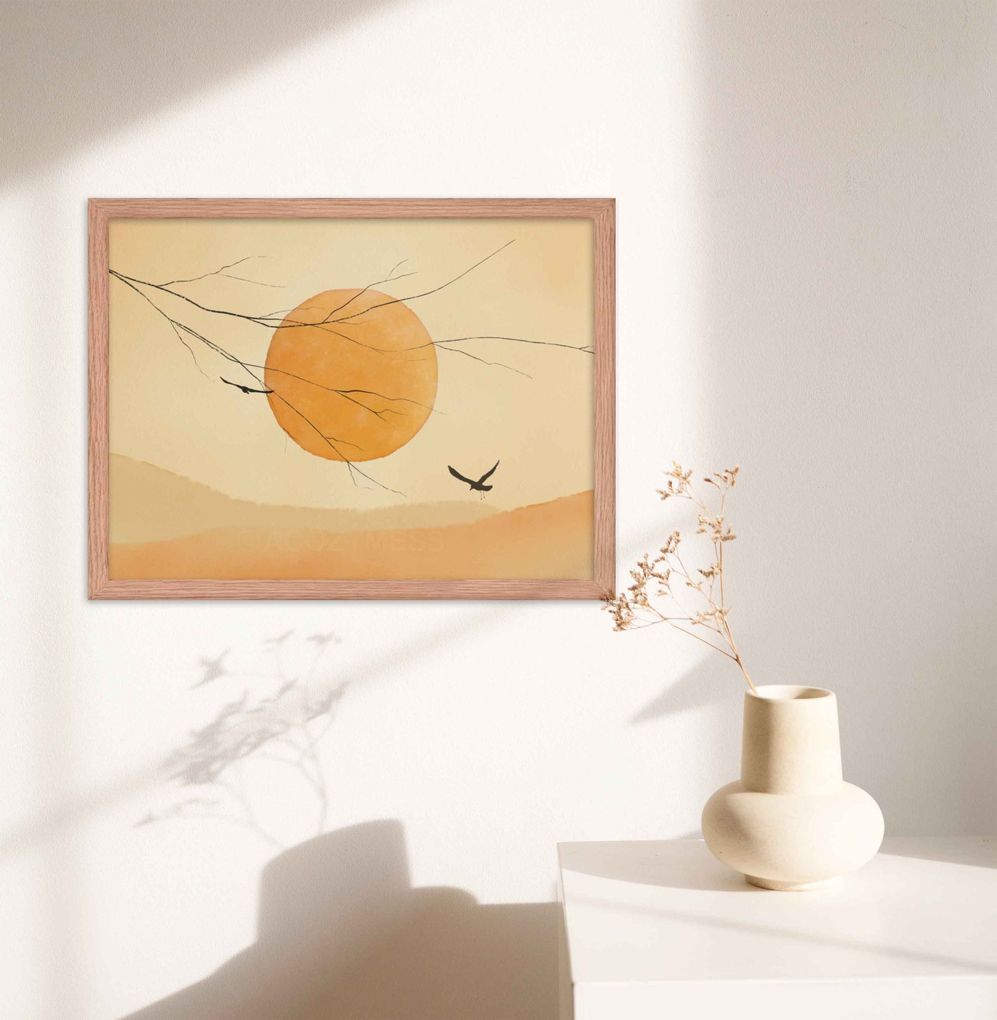 "Art print featuring a sun and flying birds in a muted yellow palette, in oakwood frame