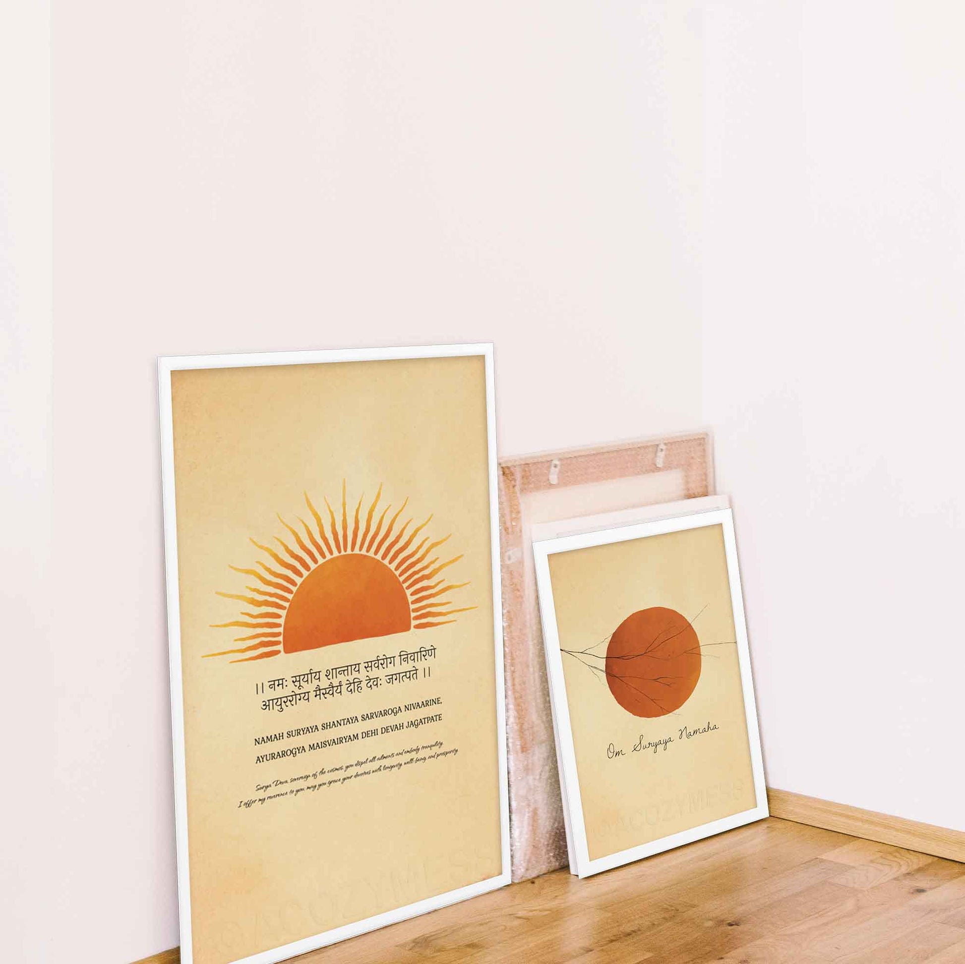 sun mantra poster with translation of mantra in english and sun art in orange, yellow, beige and black, in white frame and sun salutation mantra with sun art also in white frame