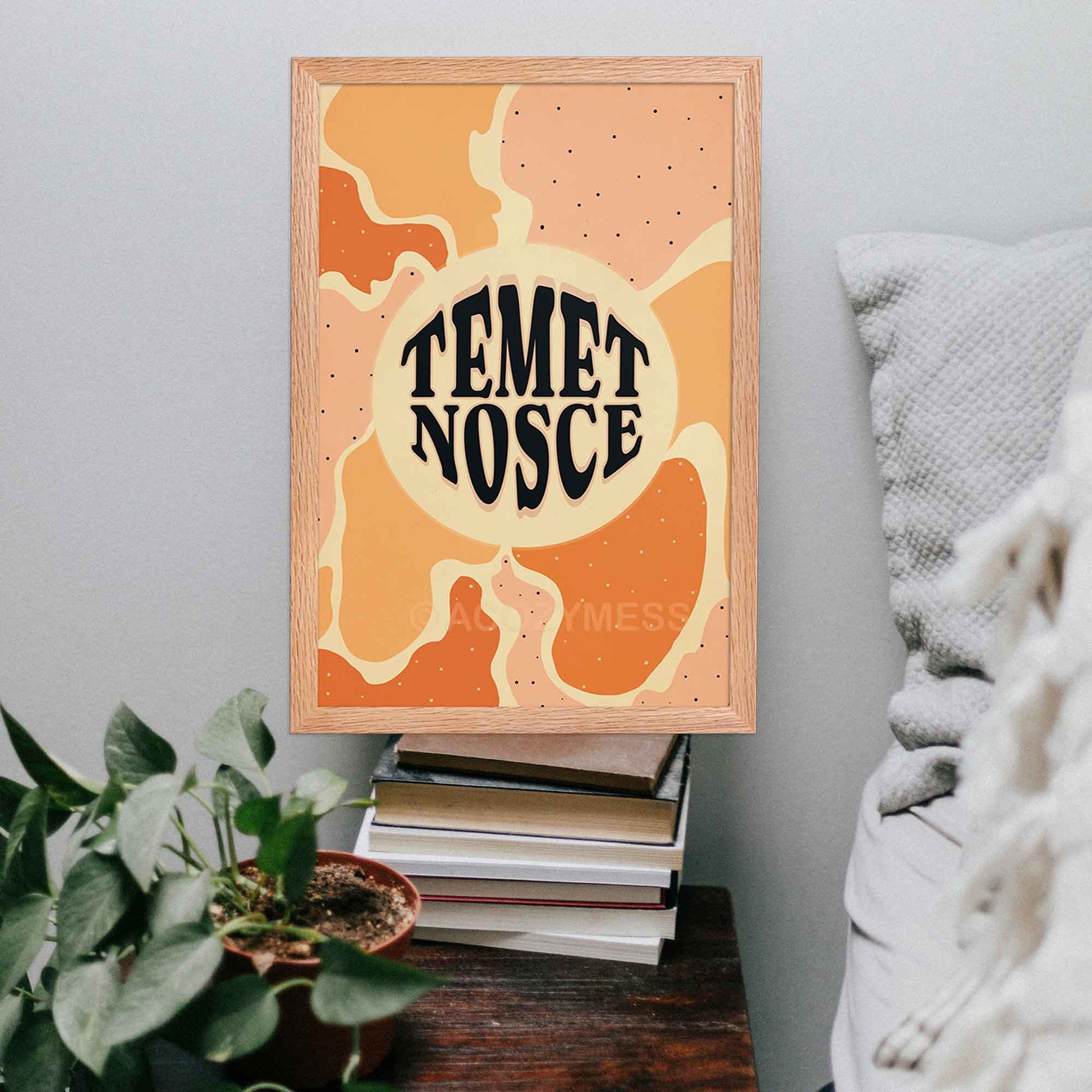 Temet nosce (know thyself) typography poster with abstract artwork in beige, yellow, orange and pink  displayed in oakwood frame. 