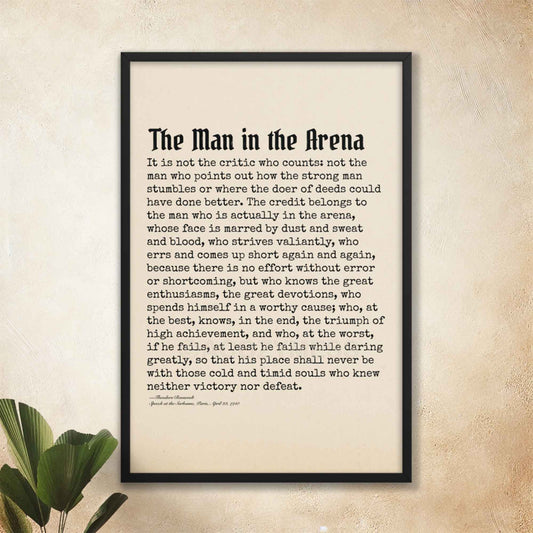 The Man in the Arena poster featuring Theodore Roosevelt's iconic quote, black on beige in black frame.