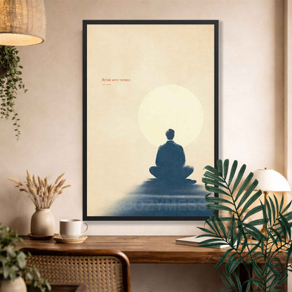 Black Framed artwork of a meditating figure with Marcus Aurelius quote above a desk.