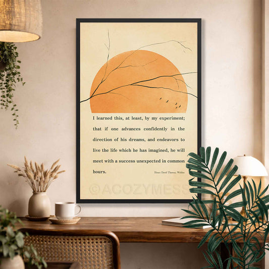Thoreau quote poster in black frame with beige background, birds and tree branches above a desk in office decor