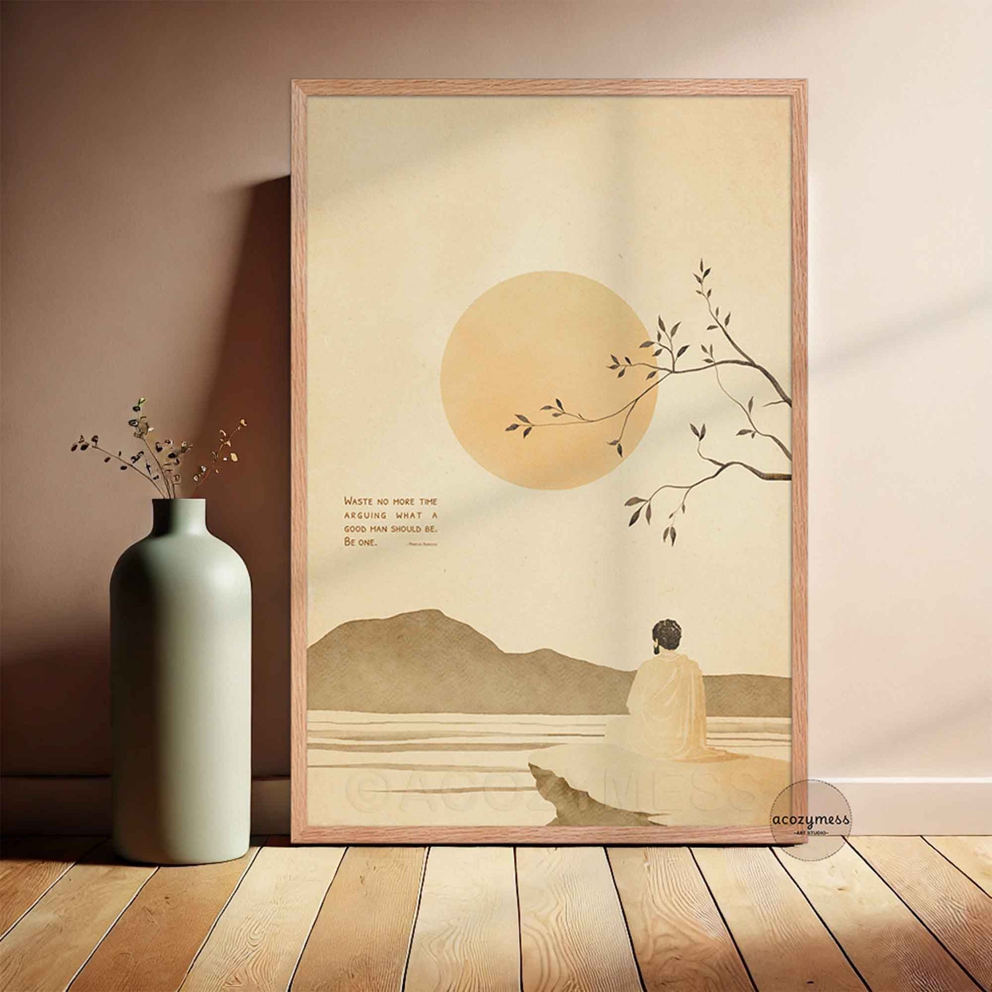 oakwood Framed stoic quote artwork of a person by a lake with a mountain and sun in the background, placed on a wooden floor.