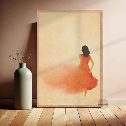 OAkwood Framed artwork of a woman in an orange dress against a beige background, next to a vase on a wooden floor.